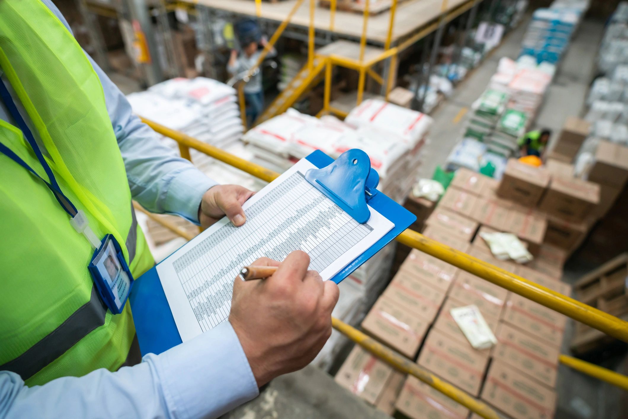 Safety auditor using a clipboard to document findings during a workplace inspection